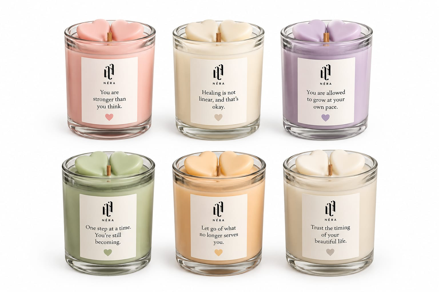 Six NÉRA Message Candles in pastel colors, each jar labeled with an inspiring message and topped with heart-shaped wax