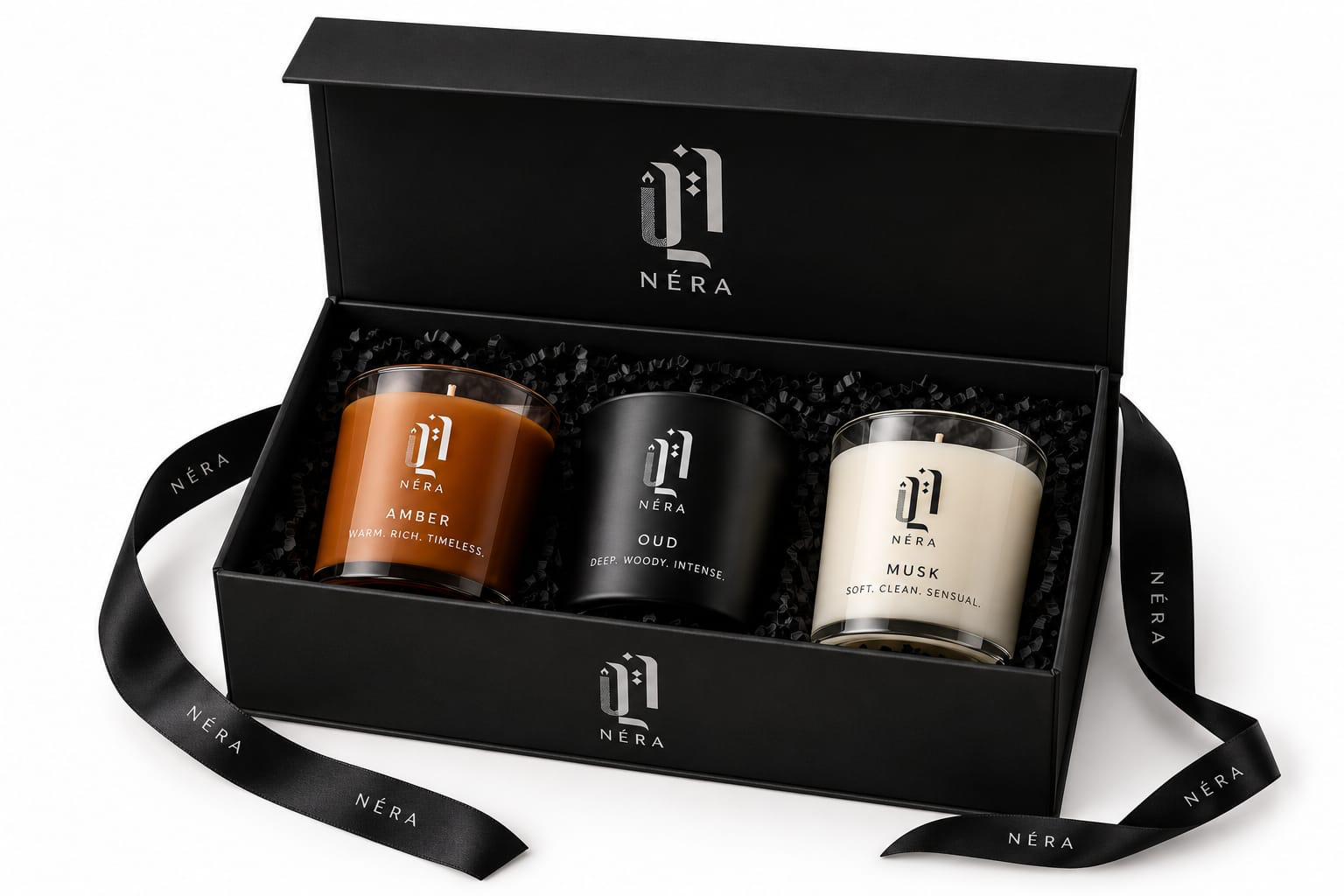 Néra For Him Gift Set, a black NÉRA gift box with Amber, Oud and Musk candles and a satin ribbon