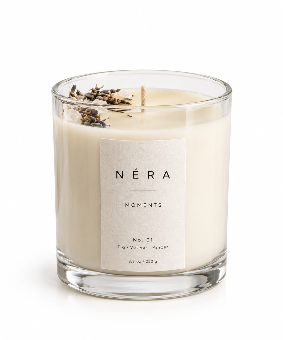 NÉRA Moments scented candle in a clear glass jar topped with lavender buds and crystals