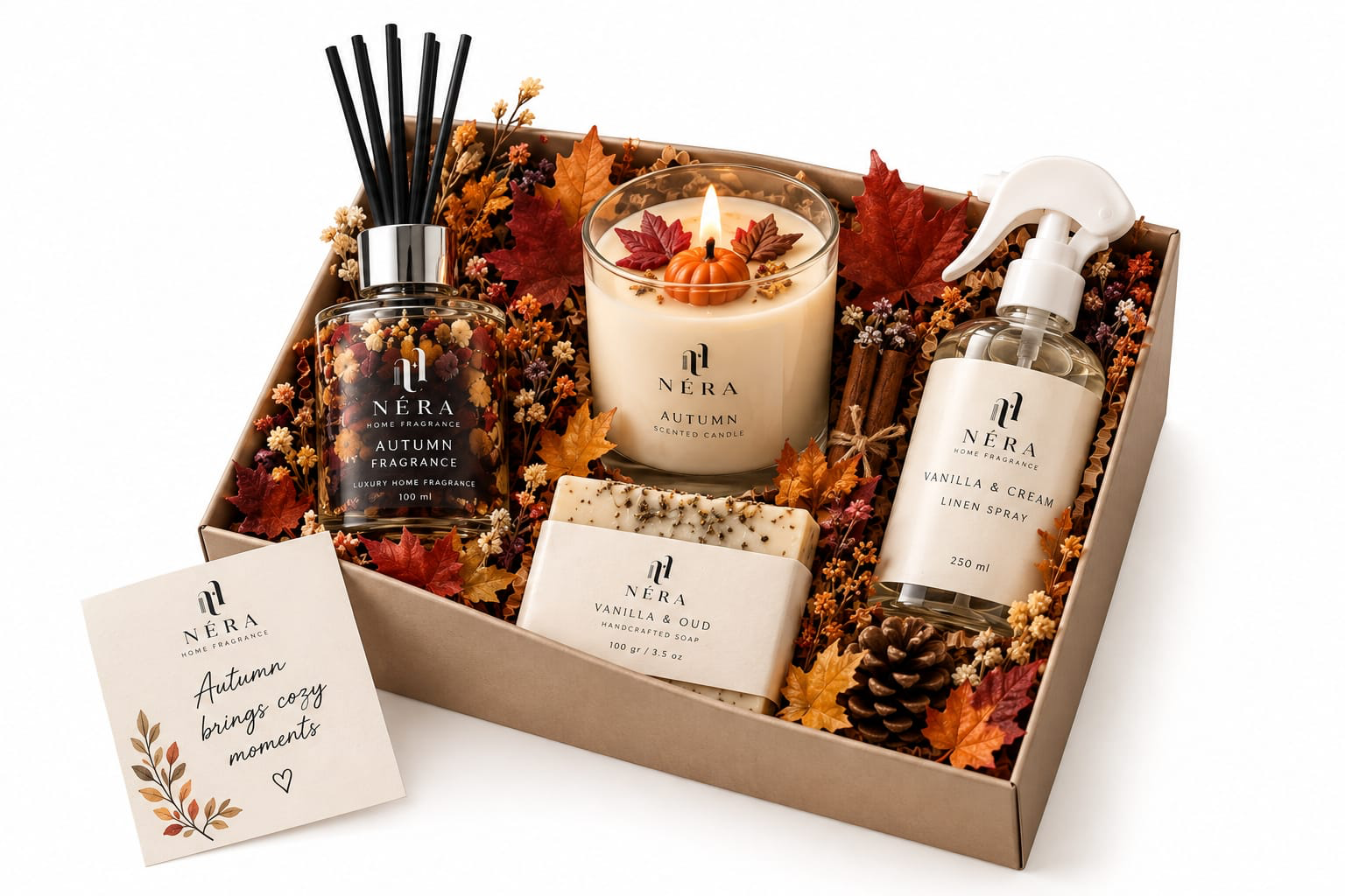 NÉRA Autumn Gift Box, a kraft box with an autumn fragrance diffuser, a scented candle, a linen spray and handcrafted soap among seasonal leaves