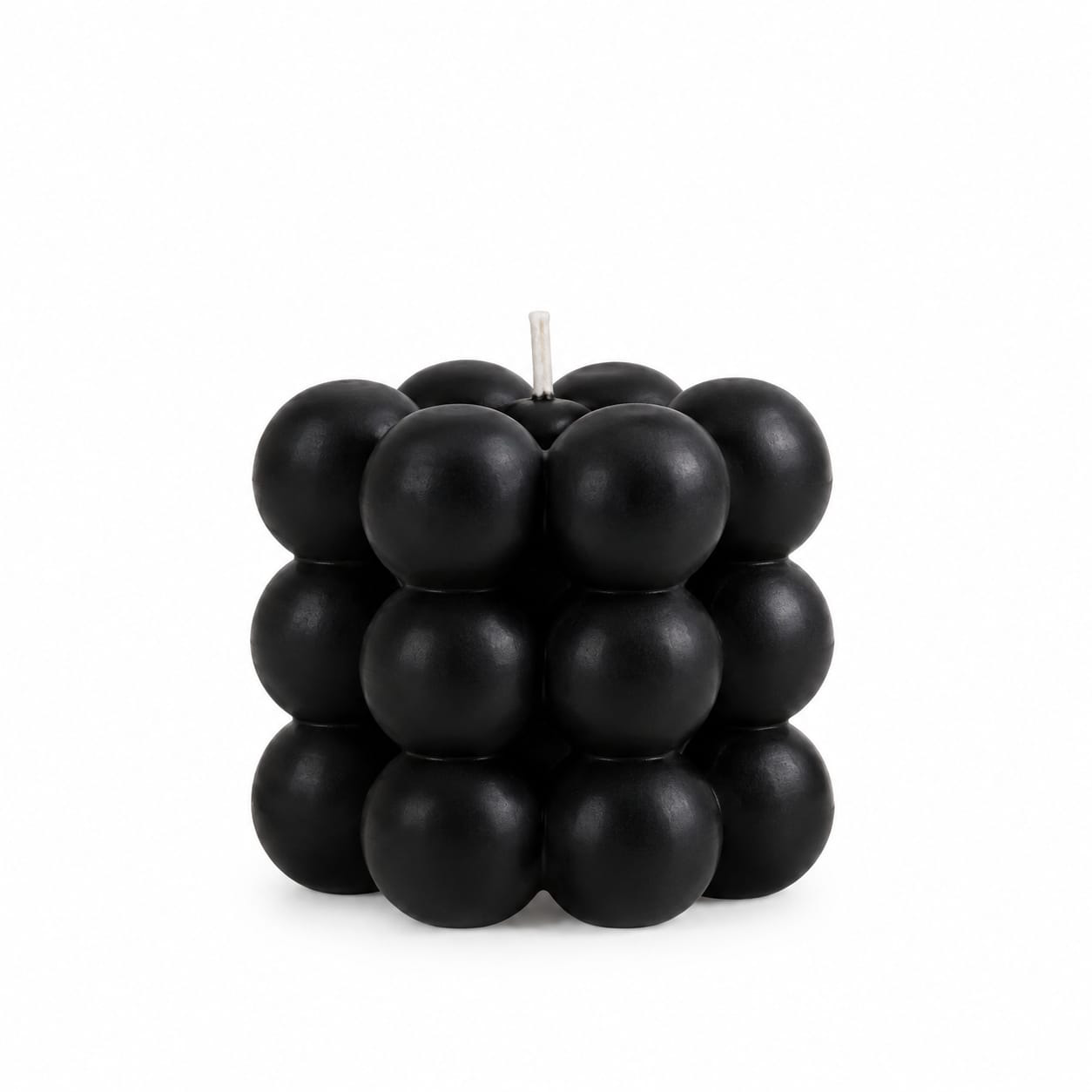 NÉRA Bubble Cube candle, a black cube candle made of rounded wax bubbles