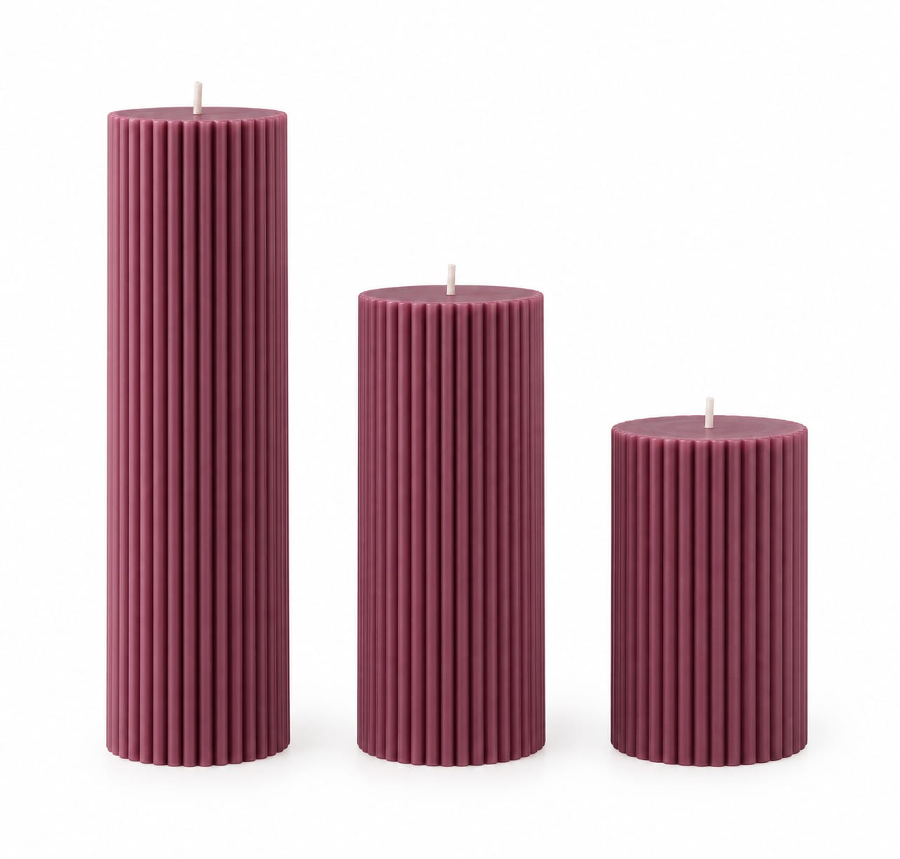 Three NÉRA ribbed pillar candles in dusty rose, in small, medium and large sizes