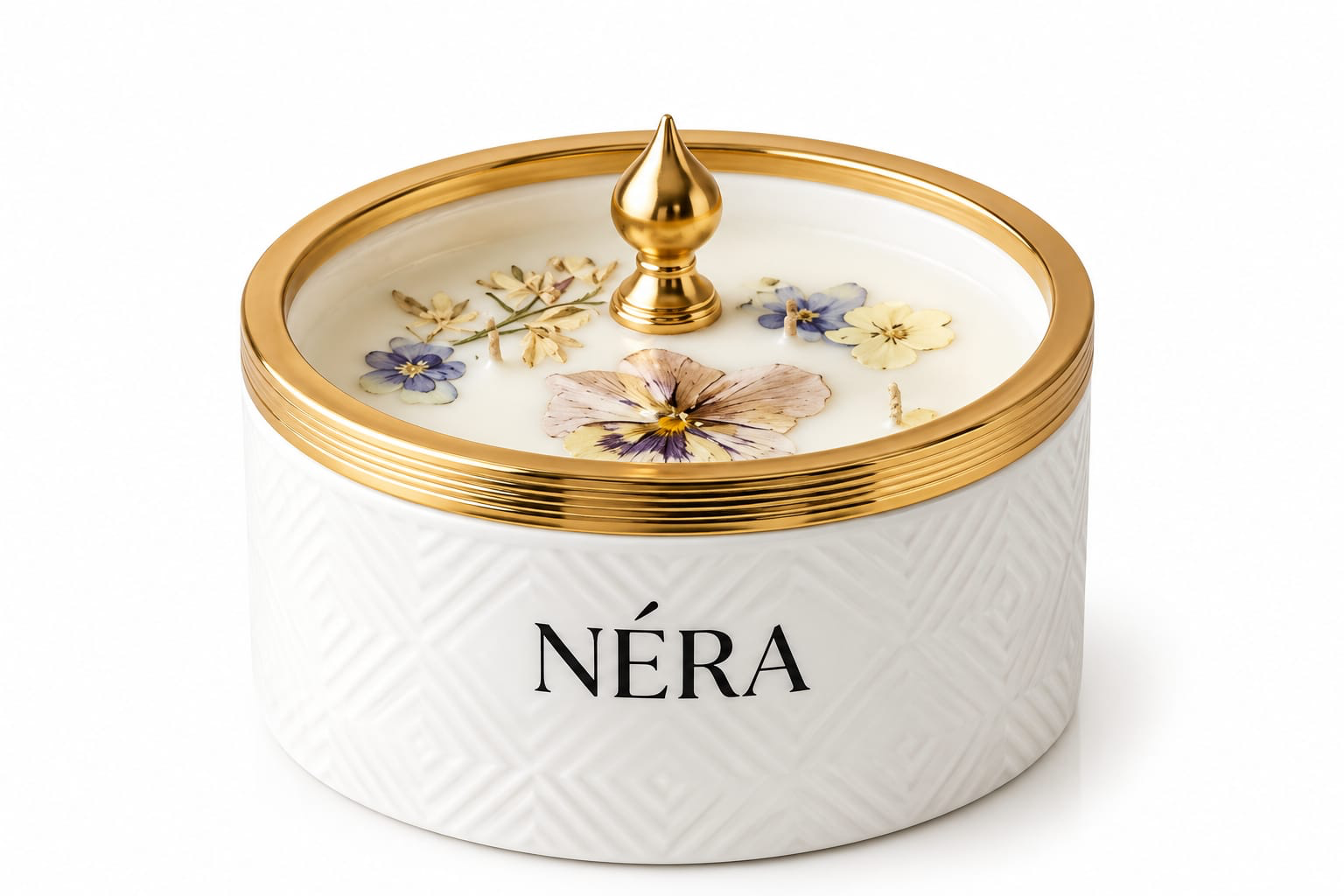 NÉRA candle in a white embossed ceramic vessel with a gold rim and dried flowers